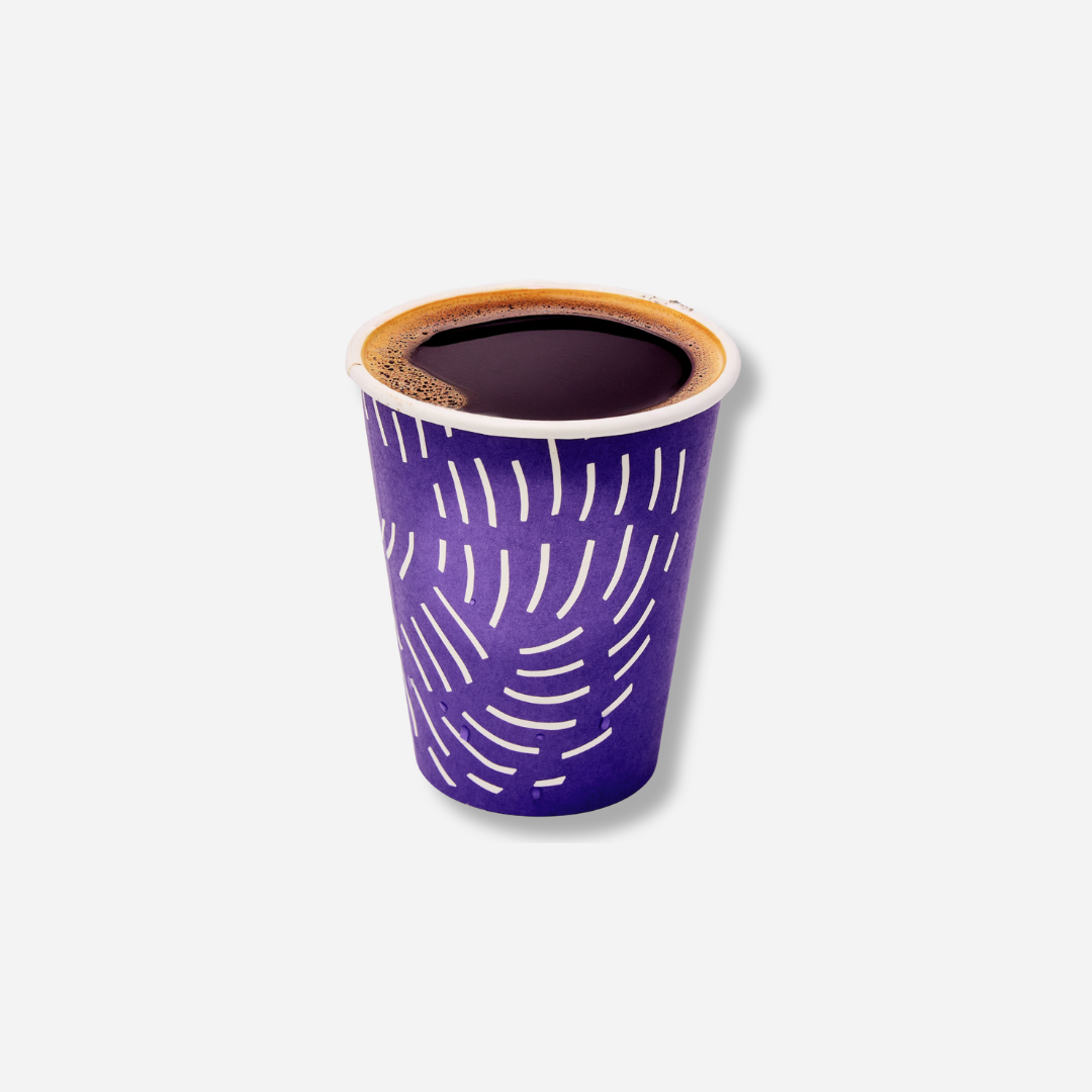 A small purple paper cup filled with hot black coffee, with white curved line patterns on the outside.