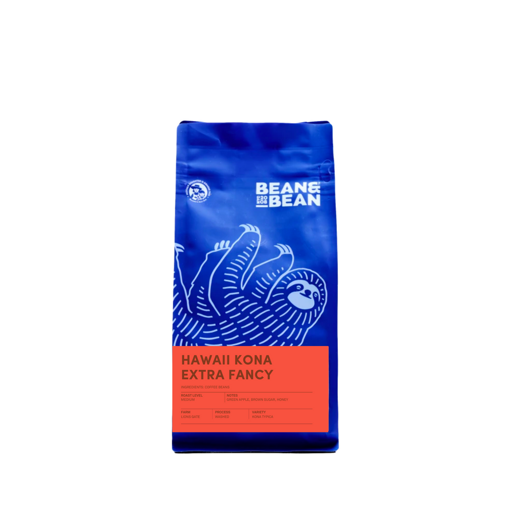 Purple "Bean & Bean Coffee Roasters" bag with a peach orange colored label that says "Hawaii Kona Extra Fancy""