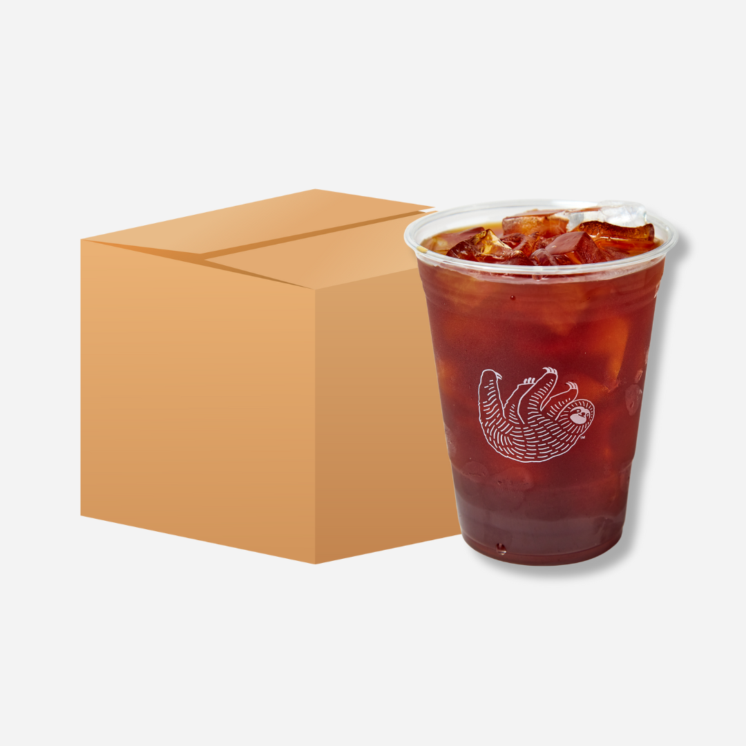 A clear plastic cup of cold brew with ice and the Bean & Bean sloth logo, shown beside a plain brown cardboard box.