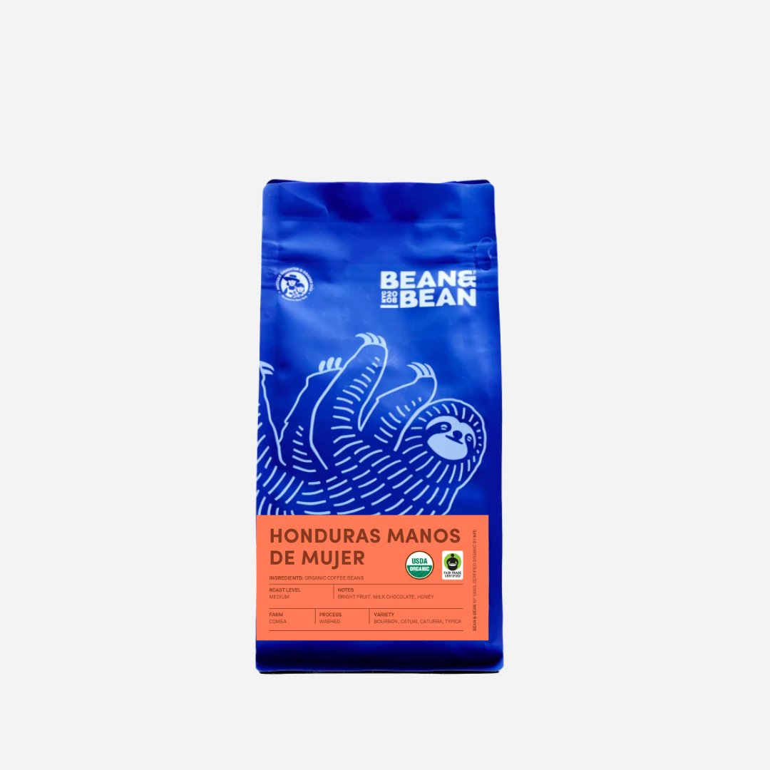 Purple "Bean & Bean Coffee Roasters" bag with a orange label that says "Honduras Manos De Mujer""