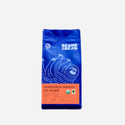 Purple "Bean & Bean Coffee Roasters" bag with a orange label that says "Honduras Manos De Mujer""