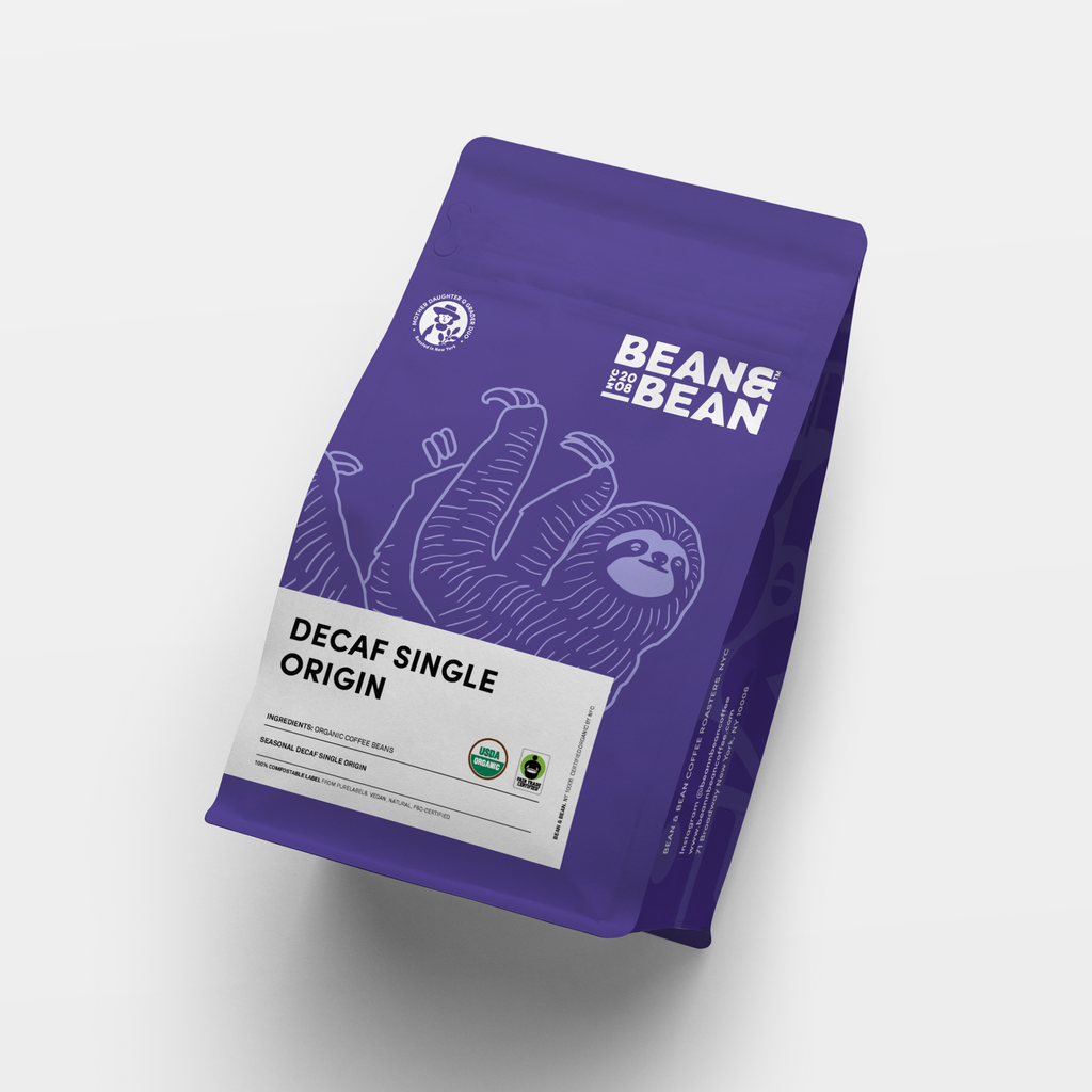 Purple "Bean & Bean Coffee Roasters" bag with a white label that says "Decaf Single Origin"
